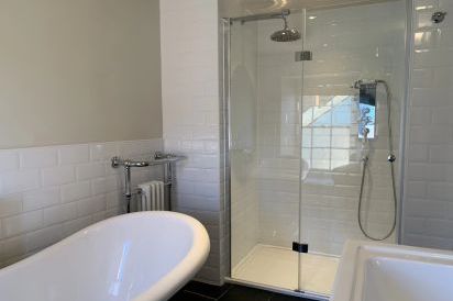 Four en-suite bathrooms with slipper bath and walk-in shower.