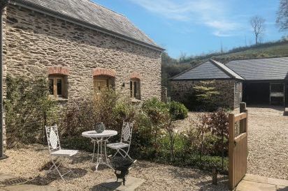 The Cowshed with patio table and chairs